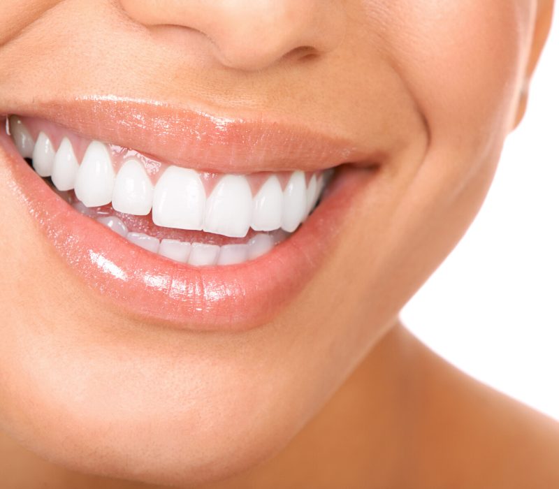 Smiling woman mouth with great teeth. Over white background